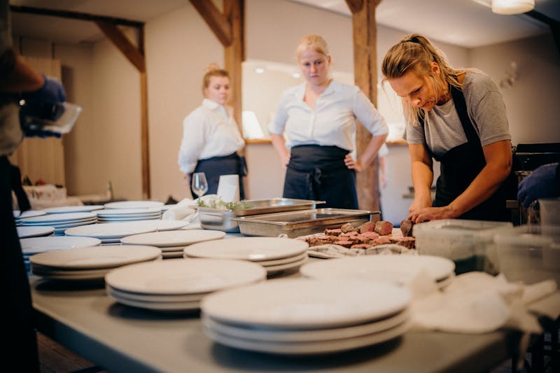 Restaurant team members working together in a professional kitchen setting